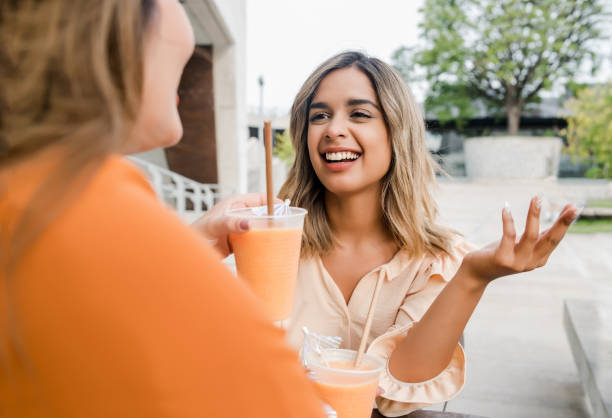 istock Two friends spending time together at coffee shop. 1295817715