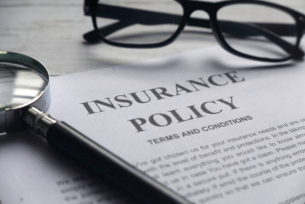 selective focus of magnifying glass,glasses and insurance policy letter on a white wooden background. - strategy imagens e fotografias de stock