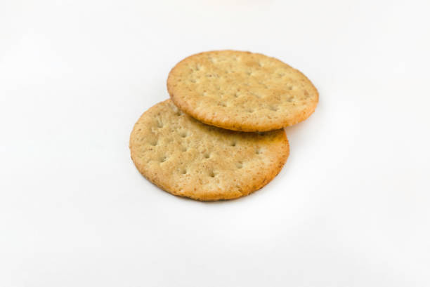 istock Selective focus of a stack of biscuits isolated on white background. 1295819444