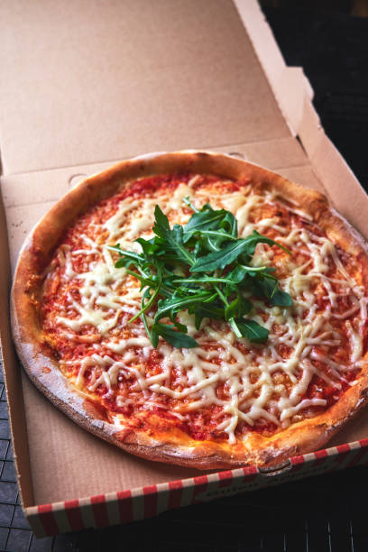 istock Pizza with Tomato Sauce, Cheese and Arugula 1295820571