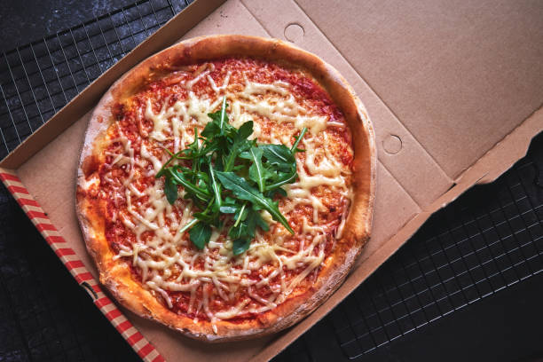 istock Pizza with Tomato Sauce, Cheese and Arugula 1295820649