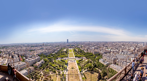 Paris, France - June 10, 2015: people watch the skyline of Paris from the upper platform at the eiffel tower.