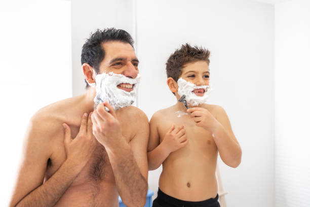 istock Funny father and son shaving in the bathroom 1295821826