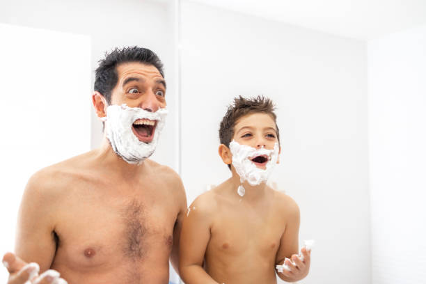 istock Funny father and son shaving in the bathroom 1295821827