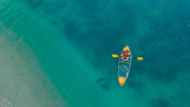 istock blue sea with floating kayak 1295824707