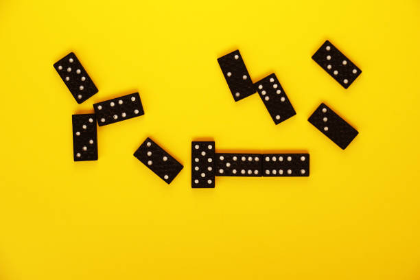 istock black domino bones on yellow background close up 1295825061