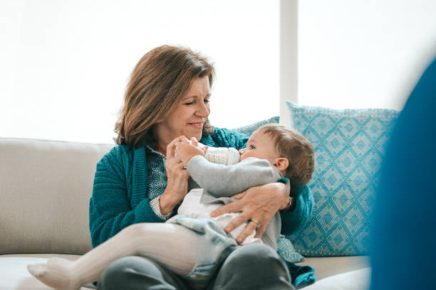 istock Grandmother feeding baby 1295825399
