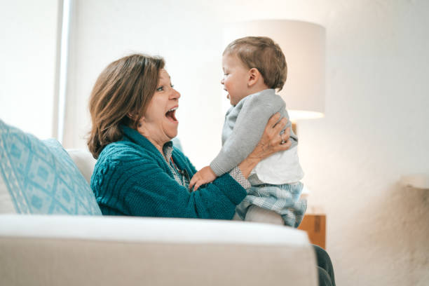 istock Grandmother feeding baby 1295825436