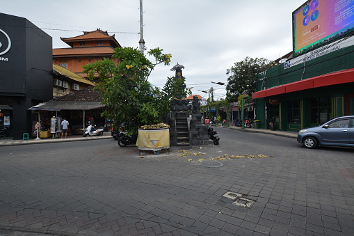 Bali, Indonesia - January 12, 2021: The streets in the city of Kuta in Bali. Restaurants and shops next to the busy streets.
