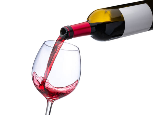 istock Pouring red wine from a bottle to a glass 1295827551
