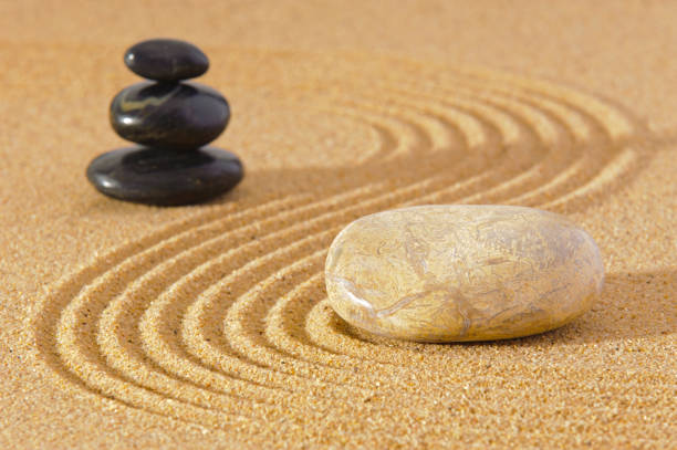 istock Japanese zen garden with stone in textured sand 1295827718