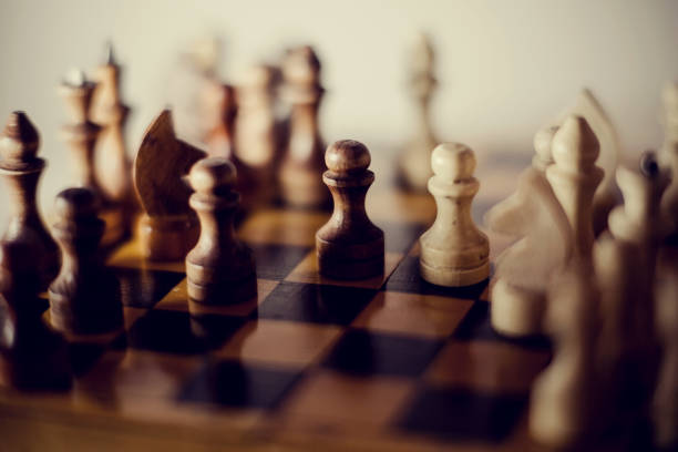 istock Wooden chess pieces on the chessboard. 1295827746