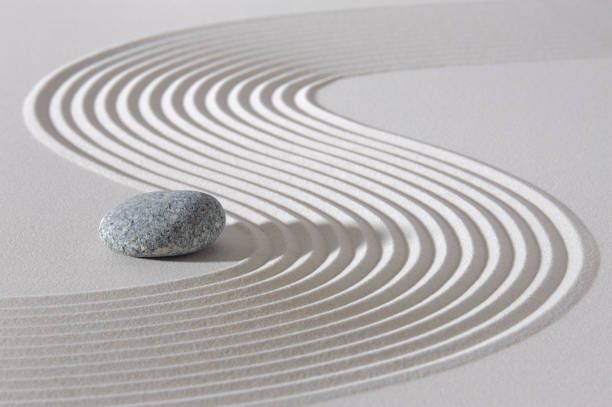 istock Japanese zen garden with stone in textured sand 1295828103