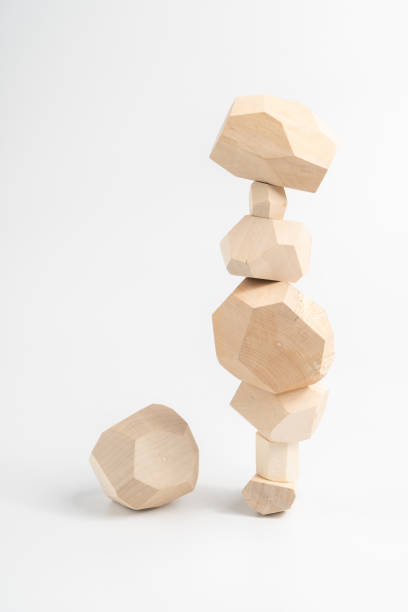 istock Tumi-ishi puzzle game. One element next to an unstable wooden stone tower. An extra or missing item. Stones for Rock Balance. 1295828162
