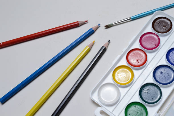 istock paint for drawing watercolor, pencils and brush. on white background. 1295832412