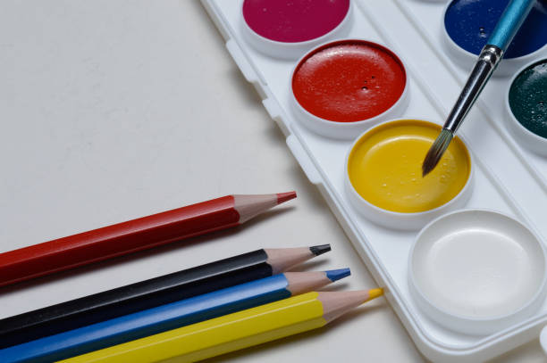 istock paint for drawing watercolor, pencils and brush. on white background. 1295832425