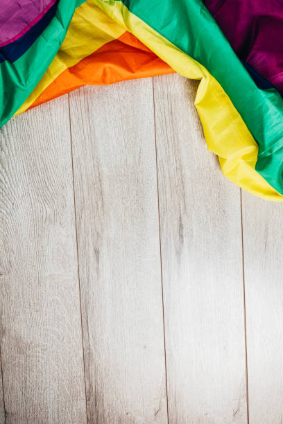 istock LGBTQI rainbow flag on wooden background 1295833276