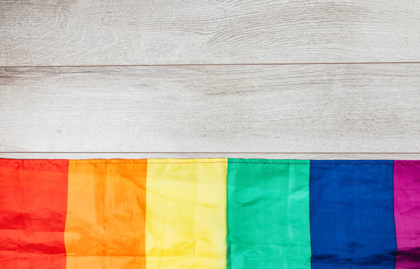 LGBTQI rainbow flag on wooden background Concept of LGBTQI rainbow flag on wooden background, top view, flat lay. rainbow flag photos stock pictures, royalty-free photos & images