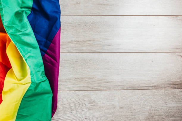 istock LGBTQI rainbow flag on wooden background 1295833357
