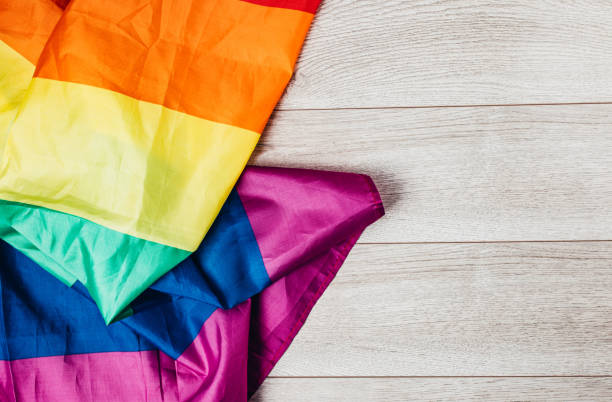 istock LGBTQI rainbow flag on wooden background 1295833378