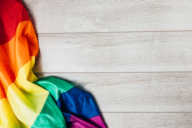istock LGBTQI rainbow flag on wooden background 1295833402