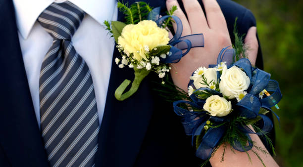 Hands of date Prom night flowers corsage formal wear hand on shoulder stock photo