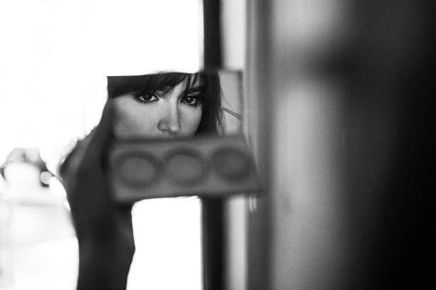 istock Attractive young woman doing make-up while looking at the mirror 1295834781