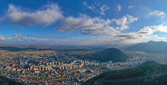 Aerial cityscape in mountain area, drone view of Piatra Neamt city in Romania.