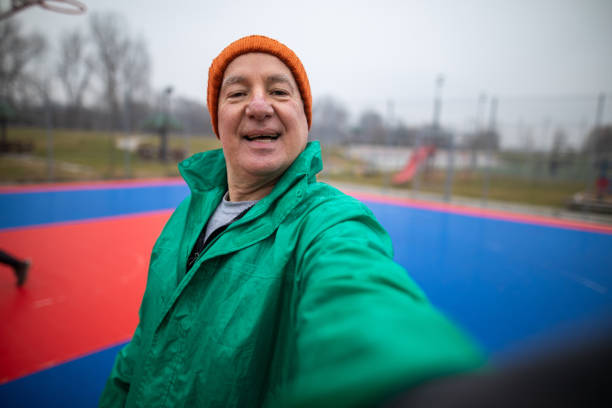 istock Senior man taking a selfie while exercising outdoors 1295836413