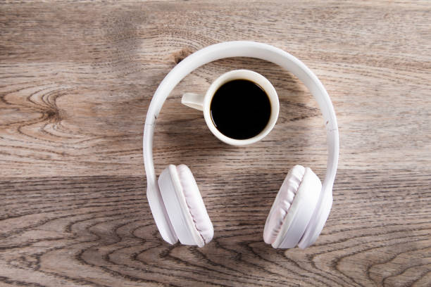 istock earphone with coffee on wooden table 1295836490