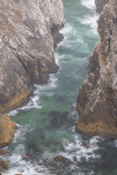istock Atlantic Cliff Rocks in long Explosure with Fog 1295837428