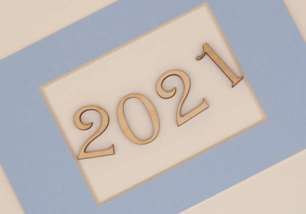 istock wooden numbers 2021 in a blue frame on a light background 1295837870