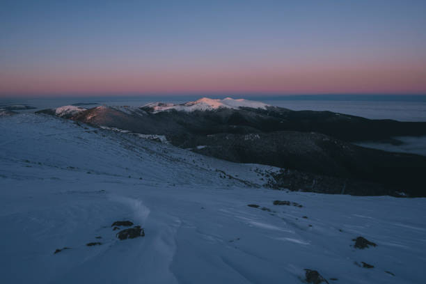 istock Sunrise first light snowcapped mountains peaks against clear sky 1295838559