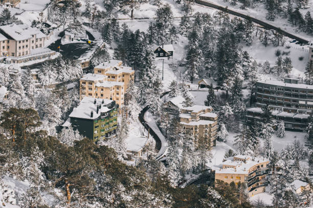 Puerto de Navacerrada village at sunset after winter snowfall, Madrid in Navacerrada, Community of Madrid, Spain