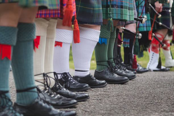 Scottish kilts and socks A row of Scottish bagpipers seen from the waist down show off their traditional Scottish men's attire. kilt stock pictures, royalty-free photos & images