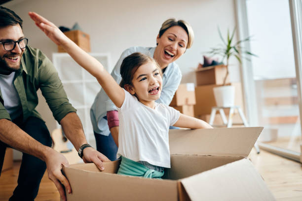 istock Cheerful family having fun while moving into their new home. 1295841703