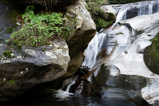 The waterfall flowing through the rocks in forest in Bursa, Turkey. Water flows are blurred. Long exposure.