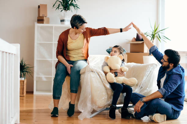 istock Happy family having fun while moving into their new home. 1295844287