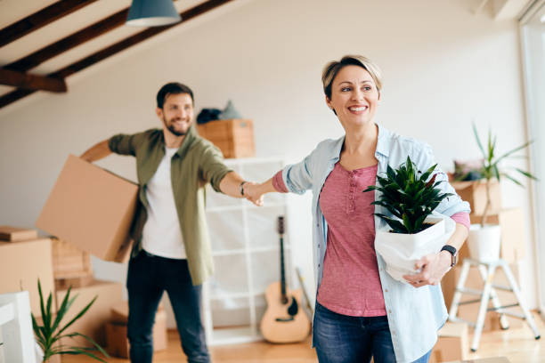 istock Carefree couple having fun while moving into their new home. 1295844637