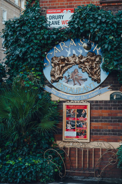 sarastro restaurant sign under the street name sign on drury lane, west end, london, uk. - drury lane imagens e fotografias de stock