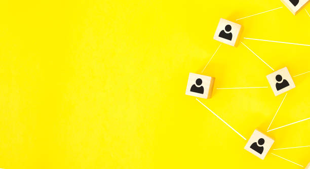 istock Organization structure, team building, recruitment, business management and human resources concepts. Person icons on wooden cubes linked to each other. 1295845247