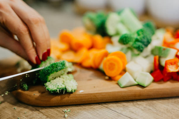 istock Hand holding a Knife and cutting a vegetables 1295846104