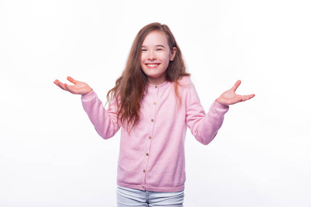 istock Smiling girl is holding arms up gesturing like she doesnt know or what. 1295846183