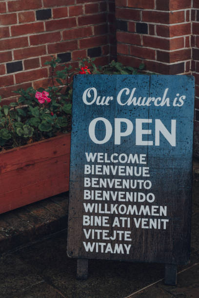 close up of open sign outside st anthony of padua church in rye, uk. - franciscan imagens e fotografias de stock