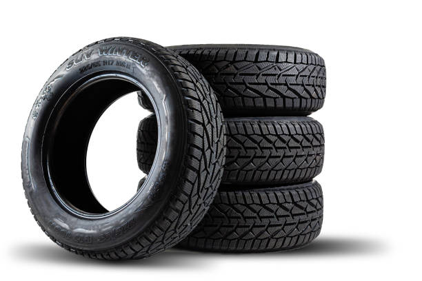 istock Stack of four new black tyres for winter car on white background 1295846483