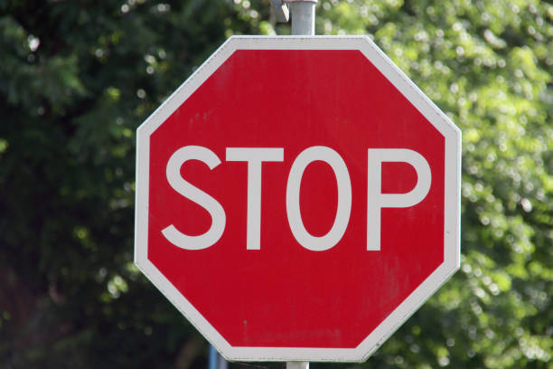 istock Red stop sign in octagon shape on the road for traffic 1295846520