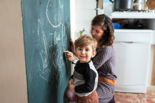 istock Mother and her son drawing chalkboard together during Lockdown 1295846622