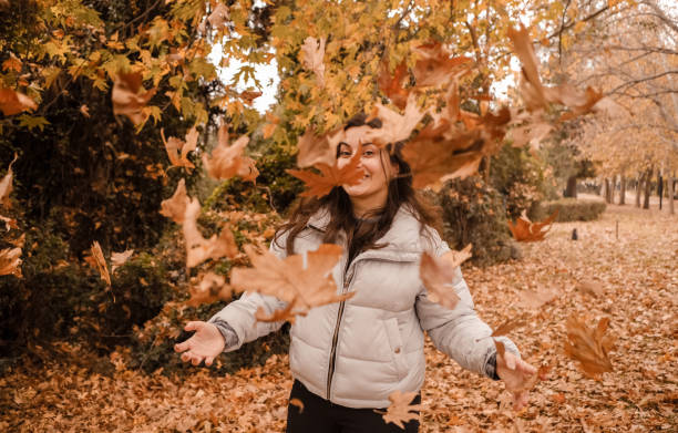 istock Beautiful woman enjoying autumn. 1295847234