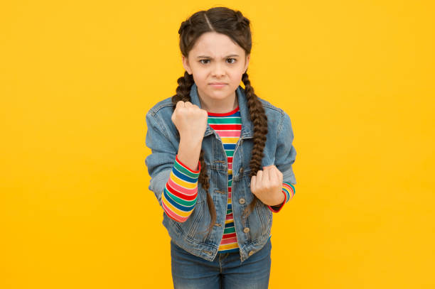 istock Little girl denim clothes threatening physical aggression, emotional control concept 1295847289