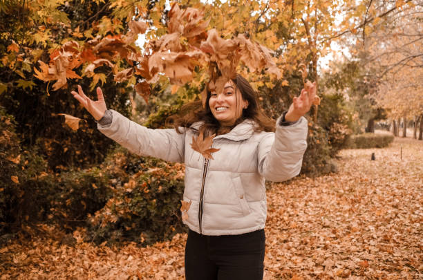 istock Beautiful woman enjoying autumn. 1295847372